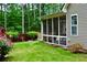 View of the screened-in porch and backyard area with mature trees and landscaping at 125 Murphy Creek Ln, Fayetteville, GA 30215