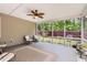 Relaxing sunroom with a ceiling fan, neutral rug, and sliding glass windows overlooking the fenced yard at 125 Murphy Creek Ln, Fayetteville, GA 30215
