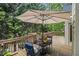 Inviting deck area with table, chairs, umbrella, and lush green backdrop at 1495 Old Hunters Lake Dr, Marietta, GA 30062