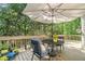 Charming deck with outdoor seating, potted plants, and peaceful view at 1495 Old Hunters Lake Dr, Marietta, GA 30062