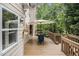 Relaxing deck area with outdoor seating, umbrella, and serene backyard view at 1495 Old Hunters Lake Dr, Marietta, GA 30062