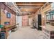 Unfinished basement with workbench, storage shelves, and access to utility area at 1495 Old Hunters Lake Dr, Marietta, GA 30062