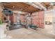Unfinished basement with exposed ceiling, gym equipment, and doorway to finished room at 1495 Old Hunters Lake Dr, Marietta, GA 30062