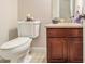 Powder room features a marble countertop and dark wood cabinets at 1495 Old Hunters Lake Dr, Marietta, GA 30062