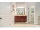 The bathroom boasts a wooden vanity with tiled floors and opens up to a bright view to the outside at 1495 Old Hunters Lake Dr, Marietta, GA 30062