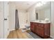 Well-lit bathroom with walk-in shower, modern vanity, and tile flooring at 1495 Old Hunters Lake Dr, Marietta, GA 30062