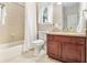 Cozy bathroom offers a tiled shower and tub combination next to a wooden vanity at 1495 Old Hunters Lake Dr, Marietta, GA 30062