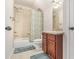 Bathroom with tiled walls, tub with shower, and a wood vanity with a sink at 1495 Old Hunters Lake Dr, Marietta, GA 30062