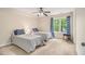 Bright bedroom featuring two twin beds, ceiling fan, and a view of the outdoors at 1495 Old Hunters Lake Dr, Marietta, GA 30062