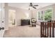 Bedroom with window, ceiling fan, dark wood furniture, view to bathroom, and a comfortable rocking chair at 1495 Old Hunters Lake Dr, Marietta, GA 30062