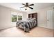 Comfortable bedroom with ceiling fan, natural light from the window, and a bed with a decorative headboard at 1495 Old Hunters Lake Dr, Marietta, GA 30062