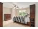 Inviting bedroom featuring a ceiling fan, natural light from the window, bed with storage and built-in shelving at 1495 Old Hunters Lake Dr, Marietta, GA 30062