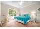 Sunlit bedroom features a double bed with turquoise bedding, side tables, and views to the outside at 1495 Old Hunters Lake Dr, Marietta, GA 30062