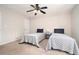 Bedroom features two twin beds with patterned bedding beneath a ceiling fan at 1495 Old Hunters Lake Dr, Marietta, GA 30062