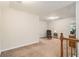 Bright bonus room features neutral carpet and walls, with a cozy sitting area and a view to the side yard at 1495 Old Hunters Lake Dr, Marietta, GA 30062