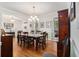 Elegant dining room with hardwood floors, a stylish chandelier, and views of the outdoors from shuttered windows at 1495 Old Hunters Lake Dr, Marietta, GA 30062