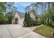 Exterior view of home with long driveway and manicured landscaping at 1495 Old Hunters Lake Dr, Marietta, GA 30062