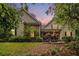 Charming home showcasing lush landscaping, stone accents, and inviting front porch under a pastel dusk sky at 1495 Old Hunters Lake Dr, Marietta, GA 30062