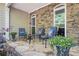 Charming front porch with stone accents, comfortable seating, and floral decor at 1495 Old Hunters Lake Dr, Marietta, GA 30062