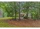 View of the front yard of the property, lined with trees at 1495 Old Hunters Lake Dr, Marietta, GA 30062