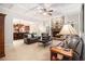Cozy living room featuring a coffered ceiling, a stone fireplace, and seamless access to the kitchen at 1495 Old Hunters Lake Dr, Marietta, GA 30062