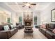 Bright living room boasts coffered ceiling, stone fireplace, and comfortable leather seating arrangement at 1495 Old Hunters Lake Dr, Marietta, GA 30062