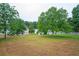 Expansive backyard featuring lush greenery and mature trees, offering a serene outdoor space at 3230 Deer Valley Nw Dr, Acworth, GA 30101