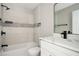 Bathroom with combo tub and shower, modern fixtures, and luxury vinyl flooring at 3230 Deer Valley Nw Dr, Acworth, GA 30101