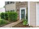 Close up of front door featuring a stone facade and manicured landscaping at 3230 Deer Valley Nw Dr, Acworth, GA 30101