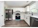 Modern kitchen with stainless steel appliances, white cabinets, dark hardware and granite countertops at 3230 Deer Valley Nw Dr, Acworth, GA 30101