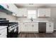 Modern kitchen features white cabinets, stainless steel appliances, and stone countertops at 3230 Deer Valley Nw Dr, Acworth, GA 30101