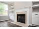 Living room featuring a fireplace and built-in shelves with light brown walls at 3230 Deer Valley Nw Dr, Acworth, GA 30101