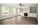 Bright living room featuring a fireplace, built-in shelves, and large windows at 3230 Deer Valley Nw Dr, Acworth, GA 30101