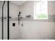 Bright bathroom shower with black hardware, gray tile, and window at 3230 Deer Valley Nw Dr, Acworth, GA 30101