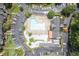 Aerial view of community pool and clubhouse surrounded by ample parking and manicured landscaping at 6851 Roswell Rd # H12, Atlanta, GA 30328