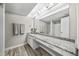 Bathroom features a large mirror, granite counters, lots of lighting, and wood-look flooring at 6851 Roswell Rd # H12, Atlanta, GA 30328