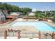 Spacious community pool area with lounge chairs, tables, and a covered patio for relaxation and socializing at 6851 Roswell Rd # H12, Atlanta, GA 30328