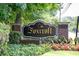 The community sign for Foxcroft Condominium with lush landscaping and flowers at 6851 Roswell Rd # H12, Atlanta, GA 30328