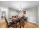 Cozy dining room featuring hardwood floors, a modern chandelier, and seating for four at 6851 Roswell Rd # H12, Atlanta, GA 30328