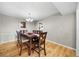 Dining room featuring hardwood floors, table with six chairs, chandelier lighting, and neutral paint at 6851 Roswell Rd # H12, Atlanta, GA 30328