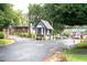 Community entrance featuring a guard house, well-maintained landscaping, and access control for added security at 6851 Roswell Rd # H12, Atlanta, GA 30328
