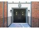 Close-up of the building entrance featuring double doors with glass panes and overhead 'H' emblem at 6851 Roswell Rd # H12, Atlanta, GA 30328