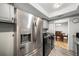 Kitchen area featuring stainless steel refrigerator, adjacent to dining room and laundry appliances at 6851 Roswell Rd # H12, Atlanta, GA 30328