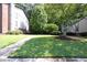Expansive lawn area with mature trees and shrubs, providing a serene and inviting outdoor space for residents at 6851 Roswell Rd # H12, Atlanta, GA 30328