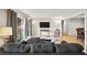 Spacious living room boasts hardwood floors, balcony access, a gray sofa, and modern lighting at 6851 Roswell Rd # H12, Atlanta, GA 30328