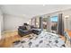 Well-lit living room featuring hardwood floors, a gray sectional sofa, and a private balcony at 6851 Roswell Rd # H12, Atlanta, GA 30328