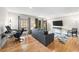 Inviting living room featuring hardwood floors, a gray sofa, balcony, and a sleek entertainment setup at 6851 Roswell Rd # H12, Atlanta, GA 30328