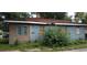 View of a neglected single-story home, showing peeling paint and overgrown bushes at 868 Oakhill Sw Ave, Atlanta, GA 30310