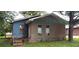 Exterior of a distressed home featuring stucco siding and a modest front yard at 868 Oakhill Sw Ave, Atlanta, GA 30310