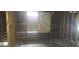 Interior view, bare walls, exposed studs, and boarded window at 868 Oakhill Sw Ave, Atlanta, GA 30310